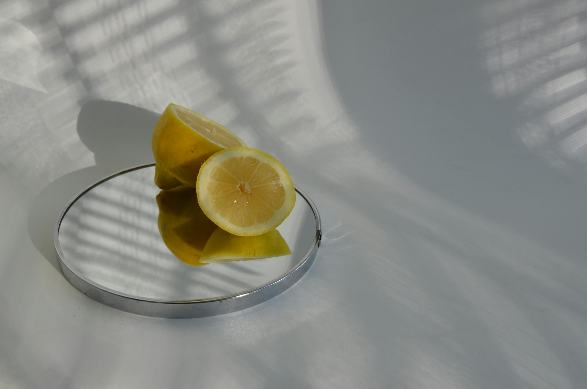 Bright yellow lemons arranged on a pastel background, symbolizing natural shifts and gentle transitions in the body